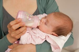 Baby feeding from anti-colic bottle