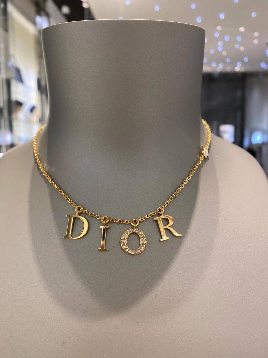 Christian Dior Gold Vintage Letter Drop Necklace  Rent Christian Dior  jewelry for 55month